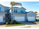 Two-story townhome with light blue exterior and two-car garage at 14138 Poppy Field Loop # 4122, Punta Gorda, FL 33955
