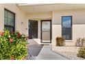 Condo entryway with door and lush landscaping at 1415 San Cristobal Ave # A4, Punta Gorda, FL 33983