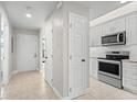 Bright kitchen with stainless steel appliances and white cabinets at 1415 San Cristobal Ave # A4, Punta Gorda, FL 33983