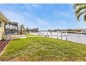 Backyard oasis with canal views, lush grass, and access to a private dock at 1435 Sea Fan Dr, Punta Gorda, FL 33950
