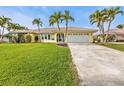 House exterior showcasing a single-Gathering home with a well-maintained lawn and driveway at 1435 Sea Fan Dr, Punta Gorda, FL 33950