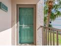 Condo building entryway with teal door and screen at 175 Kings Hwy # 528, Punta Gorda, FL 33983
