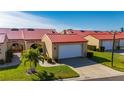Tan house with red roof and attached garage at 1780 Deborah Dr # 15, Punta Gorda, FL 33950