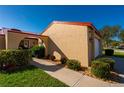 Tan stucco house with red tile roof and walkway at 1780 Deborah Dr # 15, Punta Gorda, FL 33950