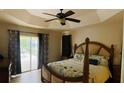 Spacious bedroom with a king-size bed and sliding glass doors leading to a patio at 18204 Ackerman Ave, Port Charlotte, FL 33948