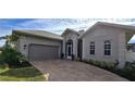 Exterior view of a single-story house with a two-car garage and manicured landscaping at 2824 Caribbean Dr, Punta Gorda, FL 33950
