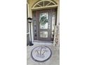 Front door entry with a circular mosaic tile and a welcome sign at 2824 Caribbean Dr, Punta Gorda, FL 33950