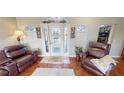 Bright living room with hardwood floors and comfortable leather furniture at 2824 Caribbean Dr, Punta Gorda, FL 33950