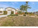 House exterior with a garage and landscaped yard at 3114 Magdalina Dr, Punta Gorda, FL 33950