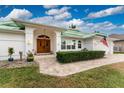 Elegant entryway with double doors and stone walkway at 3412 Nighthawk Ct, Punta Gorda, FL 33950