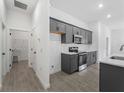 Modern kitchen featuring dark gray cabinets and quartz countertops at 4089 Felhorn St, Port Charlotte, FL 33948