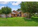 Beautiful home with a well-manicured lawn and mature trees at 4267 Adelaide Ave, North Port, FL 34288