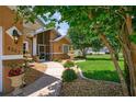 Inviting home exterior featuring a walkway, fountains, and lush landscaping at 4267 Adelaide Ave, North Port, FL 34288