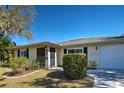 Front view of a charming one-story house with a well-maintained lawn at 514 Orlando Blvd, Port Charlotte, FL 33954