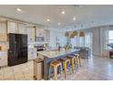 Modern kitchen with granite island and breakfast bar seating at 5274 Grove Mill Loop, Bradenton, FL 34211