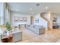 Bright living room featuring two sofas and large windows at 5274 Grove Mill Loop, Bradenton, FL 34211