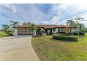 Single-story home with attached garage and manicured landscaping at 1115 Venture Ct, Punta Gorda, FL 33983