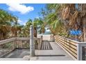 Elevated boardwalk leads to beach with palm trees at 12071 Claremont Dr, Port Charlotte, FL 33981