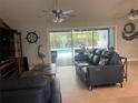 Living room with leather sofa and view of the pool at 14303 Maysville Cir, Port Charlotte, FL 33981