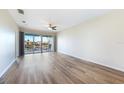 Bright living room with laminate floors and sliding glass doors leading to a balcony at 1431 Aqui Esta Dr # 221, Punta Gorda, FL 33950