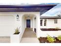 Inviting entryway with updated dark brown door and arched entry at 1612 Nuremberg Blvd, Punta Gorda, FL 33983