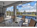 Covered patio overlooking a refreshing pool with water view at 18138 Eau Gallie Cir, Port Charlotte, FL 33948