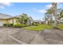 House exterior showcasing a driveway and nicely landscaped surroundings at 2110 Royal Tern Cir, Punta Gorda, FL 33983