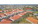 Aerial view of a community with townhouses, tennis courts, and a pool at 240 W End Dr # 412, Punta Gorda, FL 33950