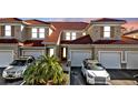 Exterior view of a two-story townhouse with two-car garage and landscaping at 240 W End Dr # 412, Punta Gorda, FL 33950