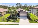 One-story house, gray siding, two-car garage, and palm trees at 2529 Sherman Oak Dr, North Port, FL 34289