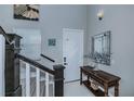 Bright and airy entryway with elegant staircase and console table at 25533 Heritage Lake Blvd # 19, Punta Gorda, FL 33983