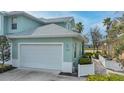 Exterior view of charming teal home with white garage door at 25533 Heritage Lake Blvd # 19, Punta Gorda, FL 33983