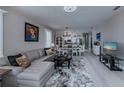 Open living room with light gray sectional sofa and view of kitchen at 25533 Heritage Lake Blvd # 19, Punta Gorda, FL 33983