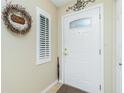 Inviting entryway with a white door and plantation shutters at 27251 Adams St # 212, Punta Gorda, FL 33983