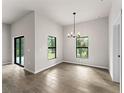 Bright dining area with tile flooring and a modern chandelier at 3733 Basket St, North Port, FL 34288