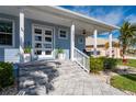 Inviting front porch with gray stone tile and white columns at 3845 Bal Harbor Blvd, Punta Gorda, FL 33950