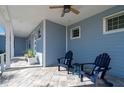 Peaceful porch with blue Adirondack chairs and a tiled floor at 3845 Bal Harbor Blvd, Punta Gorda, FL 33950