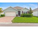 One-story house with a beige garage door and well-manicured lawn at 3861 Cobblestone Ln, Port Charlotte, FL 33980