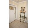 Bright entryway with tiled floors, a white door, and an ornate console table at 721 Brenda Ct, Punta Gorda, FL 33950