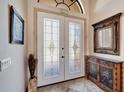 Bright entryway with glass doors and decorative console table at 1041 Harbour Park Ct, Punta Gorda, FL 33983