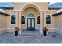 Elegant entryway with arched columns and double doors at 1041 Harbour Park Ct, Punta Gorda, FL 33983