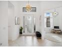 Bright and airy foyer with modern chandelier at 1099 Cimarron Dr, Punta Gorda, FL 33950