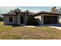 Newly constructed home with a two-car garage and well-manicured lawn at 1101 Victoria Ave, Port Charlotte, FL 33948