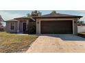 Newly constructed home with a two-car garage and well-manicured lawn at 1101 Victoria Ave, Port Charlotte, FL 33948