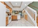 Kitchen with light wood cabinets, white appliances, and tile floor at 1246 Rio De Janeiro Ave # 509, Punta Gorda, FL 33983