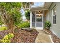 Pathway to a cozy screened porch with landscaping at 1259 Red Oak Ln, Port Charlotte, FL 33948