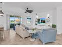 Spacious living room with beige sofa, blue armchair, and access to a patio at 14033 Black Beauty Dr # 511, Punta Gorda, FL 33955