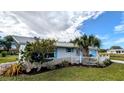 Single story home with white exterior and lush landscaping at 145 Dartmouth Nw Dr, Port Charlotte, FL 33952