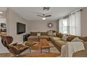 Modern living room with sectional sofa, coffee table, and large TV at 145 Dartmouth Nw Dr, Port Charlotte, FL 33952