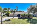 One-story house with a stone facade and lush landscaping at 18395 Edgewater Dr, Port Charlotte, FL 33948